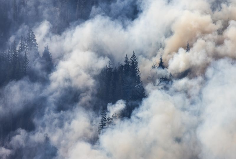 BC Forest Fire and Smoke over the mountain near Hope during a hot sunny summer day.