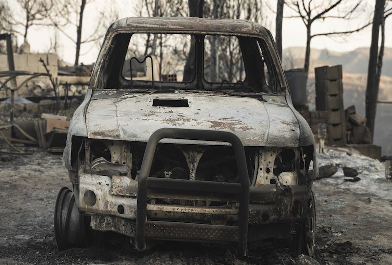 Burnt car aftermath forest fire consequence of climate change - Wildfire Crisis and Global Collapse