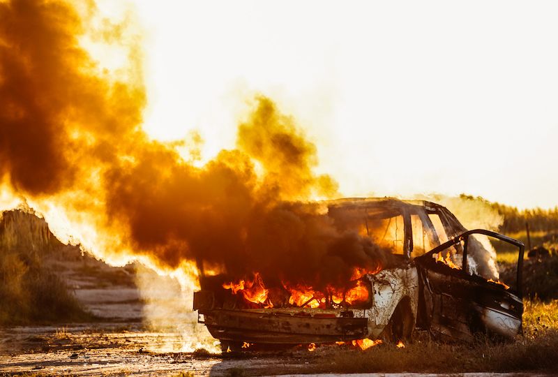 car-burning-with-open-flames-and-sunset-in-backgro-2021-08-30-02-22-23-utc