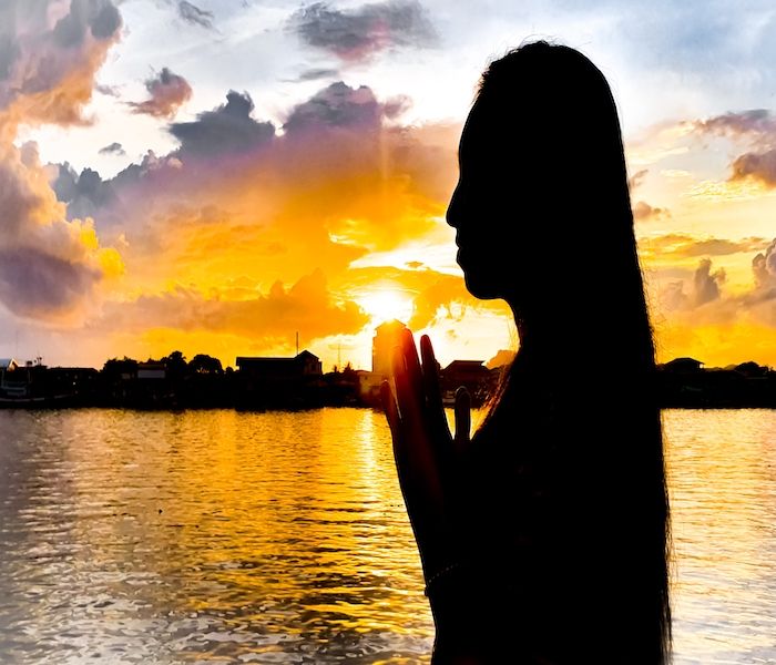 A woman praying hand for god Hope for a happy life