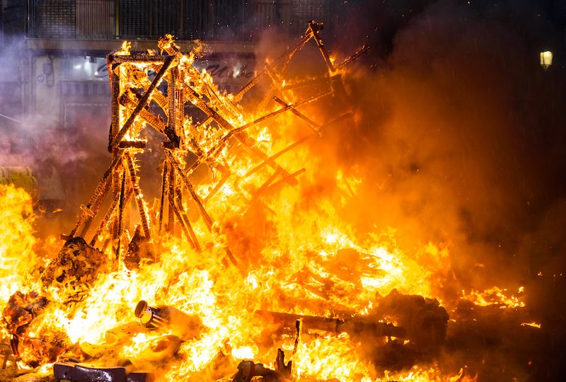 Valencia, Spain - March 19, 2019: Detail of a Falla Valenciana burning between flames of fire.